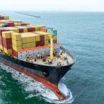 Cargo container ship carrying container and running in the ocean near international container port customs shipyard sea port concept smart logistic service. transportation logistics trading.